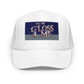 White trucker hat with 'IT'S THE GLOSS 4 ME' embroidered on front, blue and gray background.