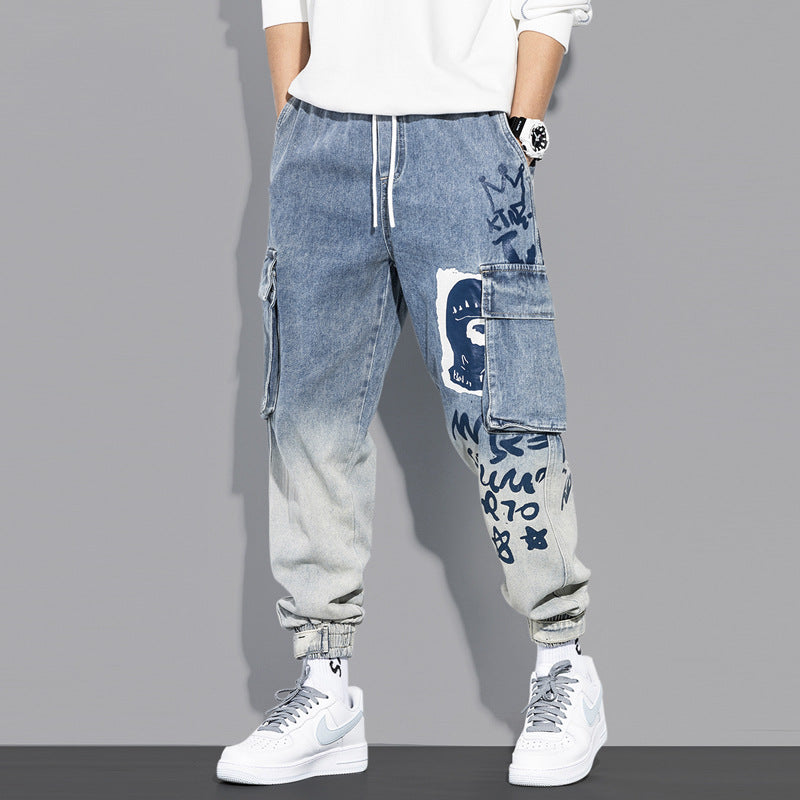 Men's blue denim cargo jogger pants with graffiti print and street style sneakers
