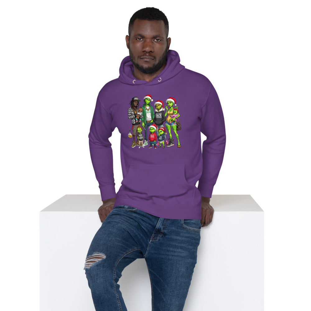 Man in purple hoodie with colorful cartoon characters, sitting on white block, distressed jeans