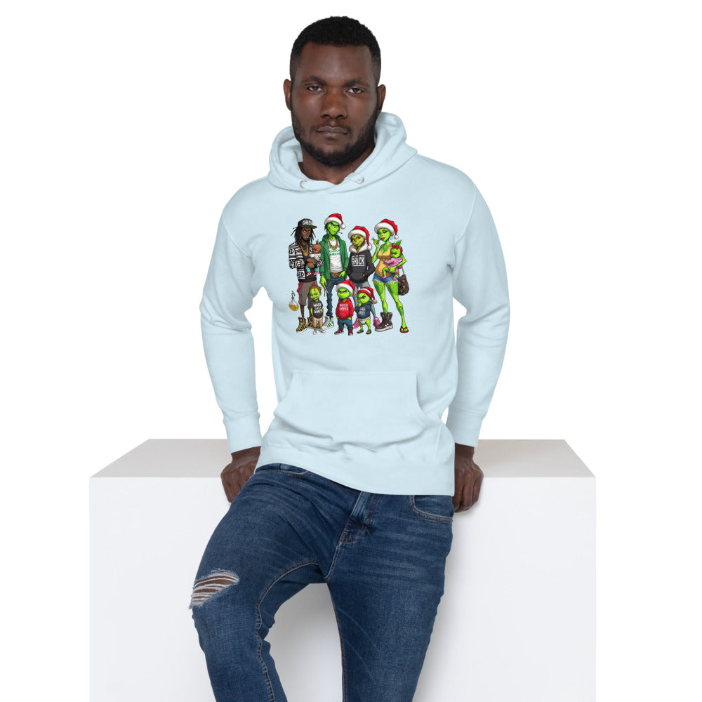 Man in light blue hoodie with colorful cartoon Grinch family graphic, ripped jeans, white background