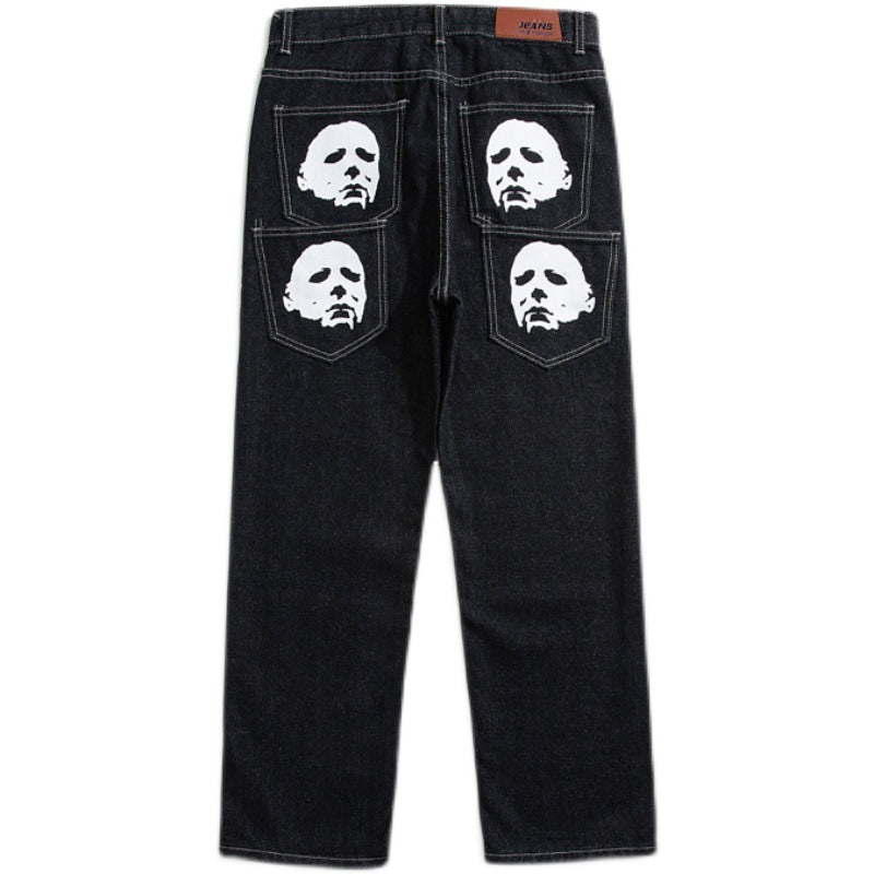 Black denim jeans with four white face prints on back pockets, streetwear style